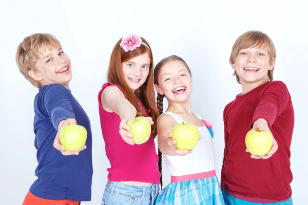 Positive friends keeping apples. — Stock Photo, Image