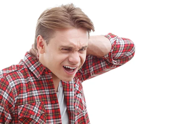 Surprised guy holding his hand on the neck — Stock Photo, Image