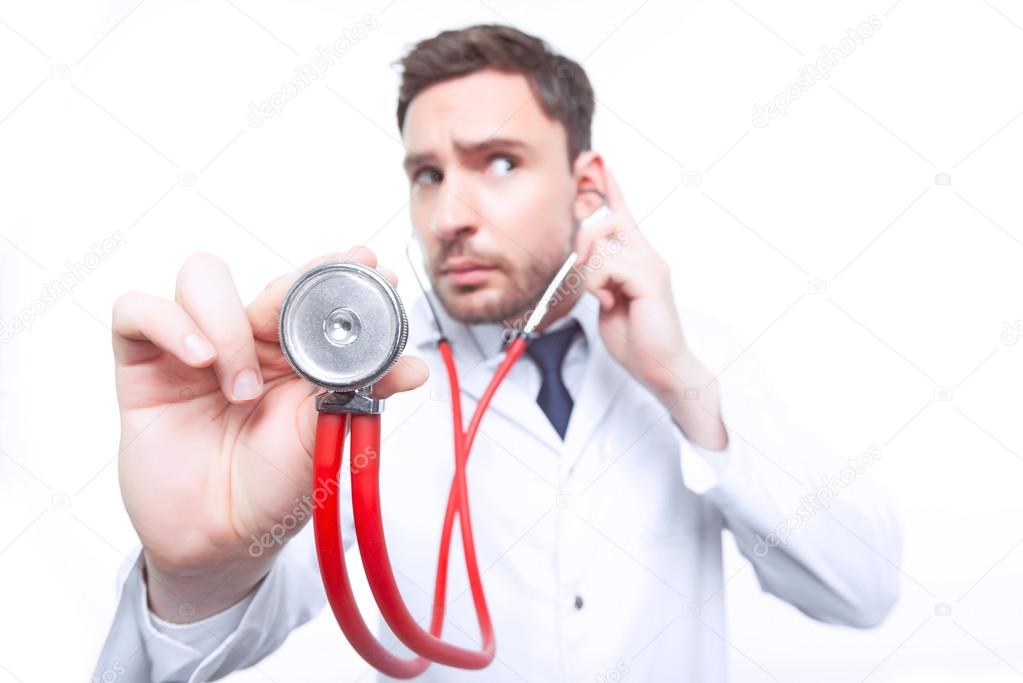 Professional cardiologist holding stethoscope 