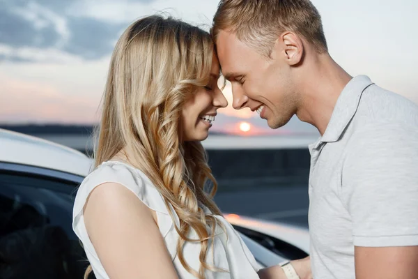 Lovely couple near the car — Stock Photo, Image