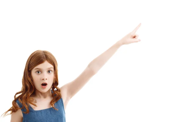 Surprised little girl pointing upwards — Stock Photo, Image