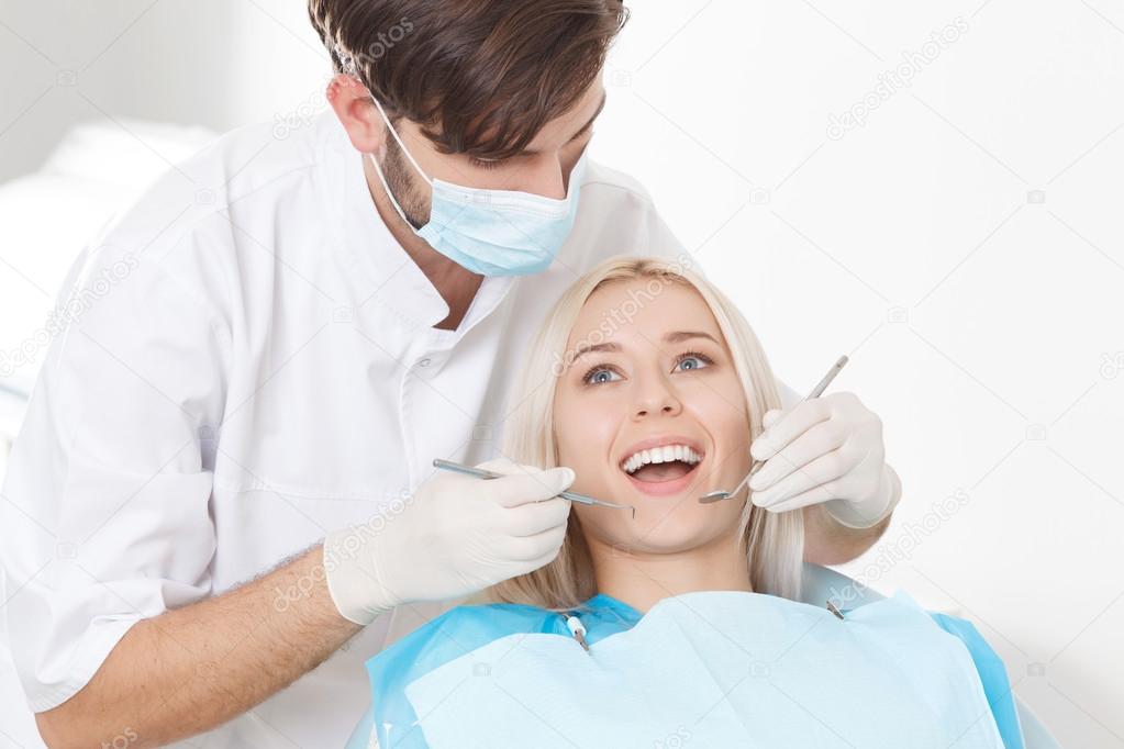 Blond-haired woman during her teeth examination 