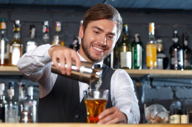 Handsome bartender during work