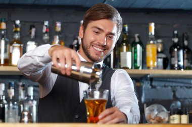 Handsome bartender during work clipart