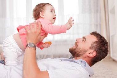 Vivacious father holding his kid in air 