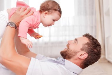Vivacious father holding his kid in air 