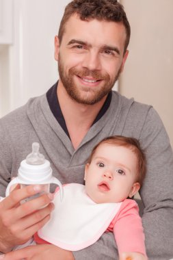 Nice daddy feeding his child 