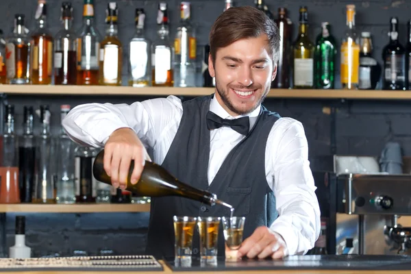 Handsome bartender making shots — Zdjęcie stockowe