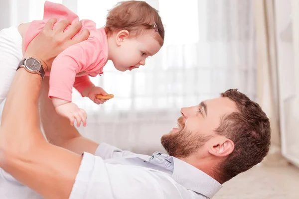 Vivacious father holding his kid in air — Stok fotoğraf