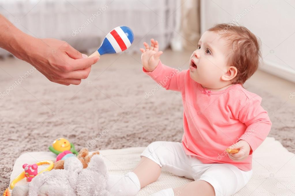 baby holding rattle
