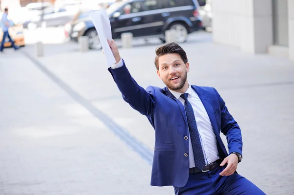 Positive businessman holding documents. — Stock Photo, Image