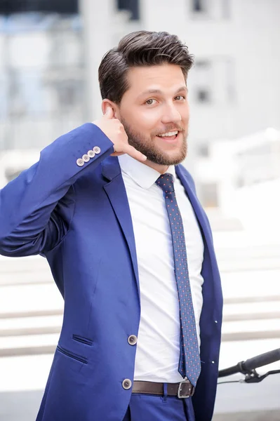 Pleasant businessman standing with bicycle — Stockfoto