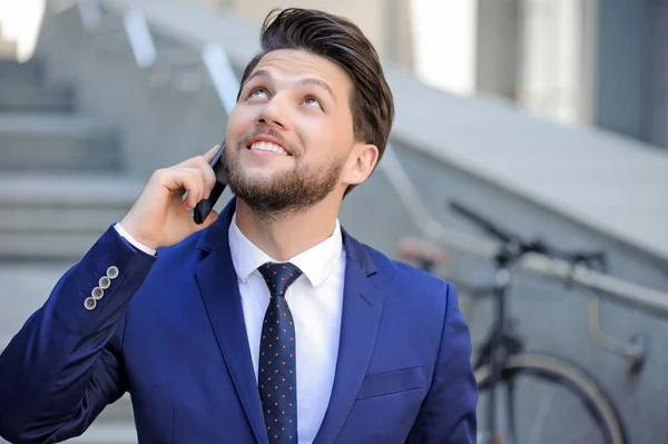 Nice businessman talking on mobile phone — Stock Fotó