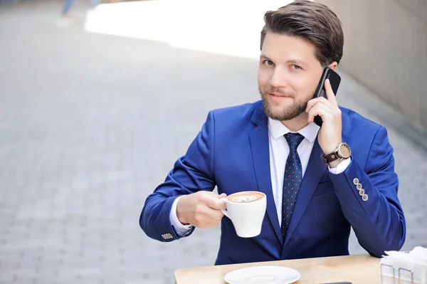 Pleasant young man sitting in cafe — Stock Photo, Image