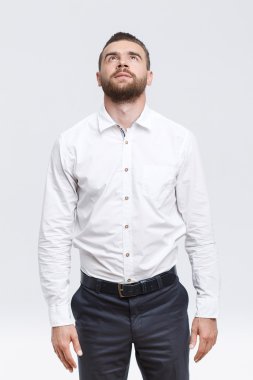 Man with beard standing and looking up 