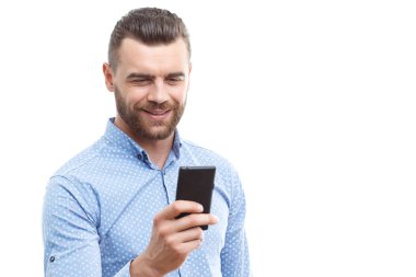 Handsome man with beard holding mobile phone 
