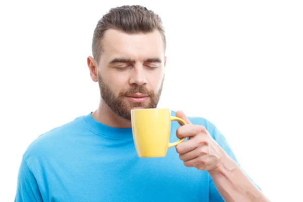 Man with beard holding cup of coffee — ストック写真