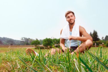 Çimenlerin üzerinde oturan güzel adam 