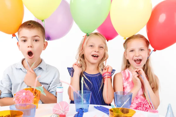 Vivacious children sitting at the table — Stock Photo, Image