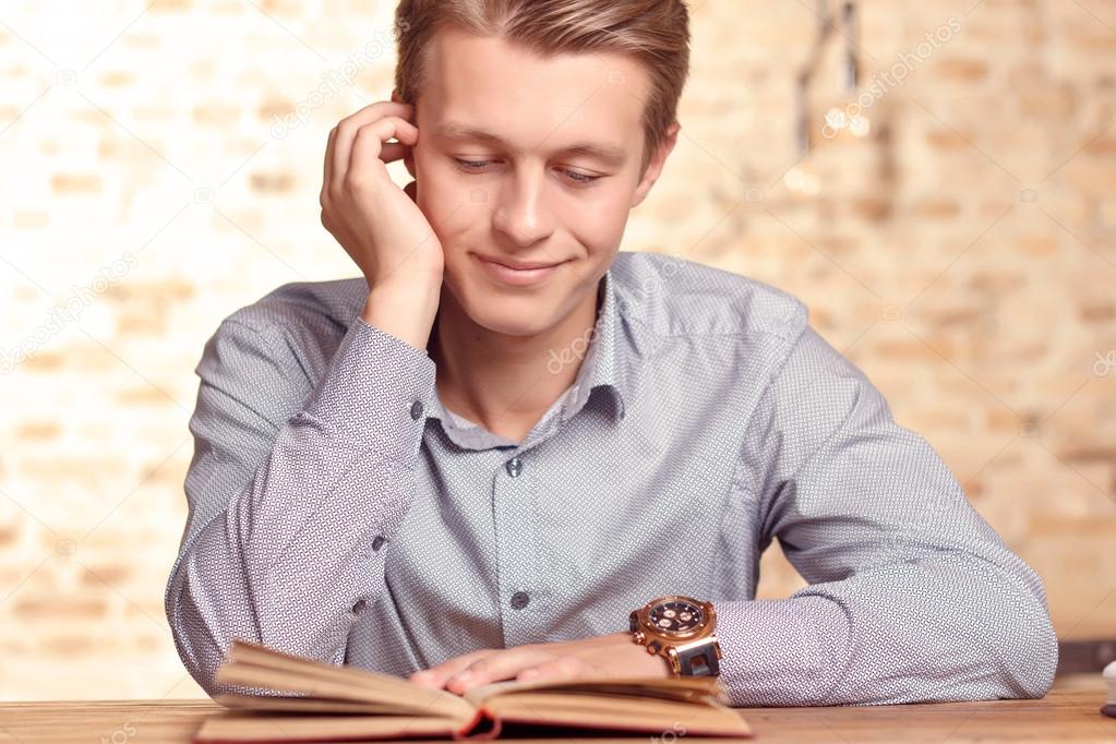 Man reading book in cafe