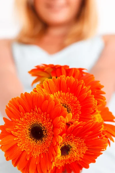 Close up of flowers held by woman — Stock Photo, Image