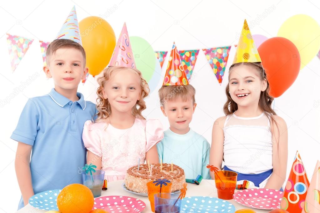 Happy children posing with birthday cake 