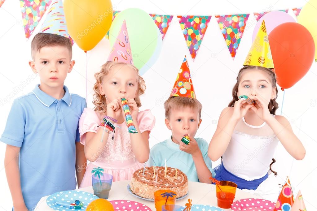 Happy children posing with birthday cake 