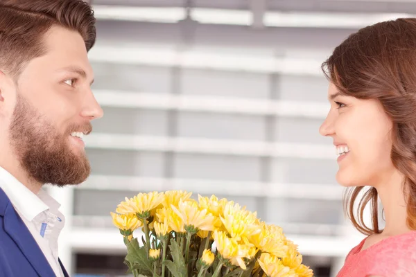 Homem apresentando flores para sua namorada — Fotografia de Stock