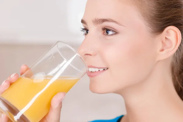 Smiling girl drinking juice — Stok fotoğraf