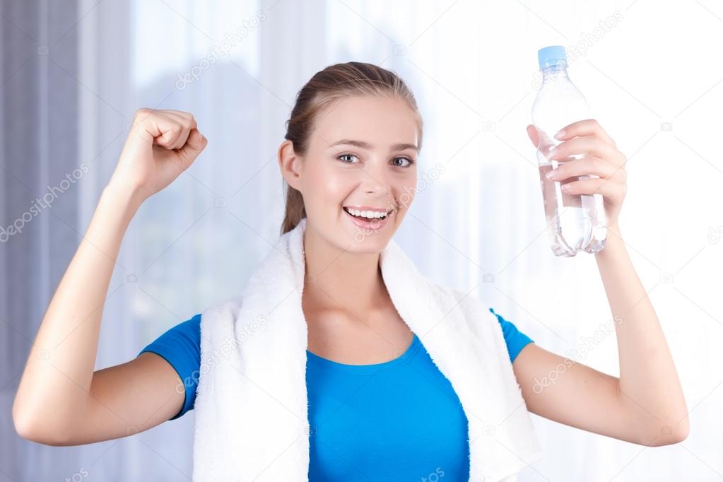 Pleasant girl drinking water 