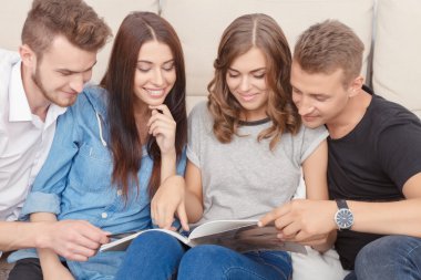  Happy friend reading magazine 