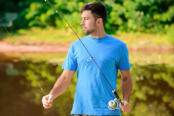 Pleasant man fishing — Stockfoto