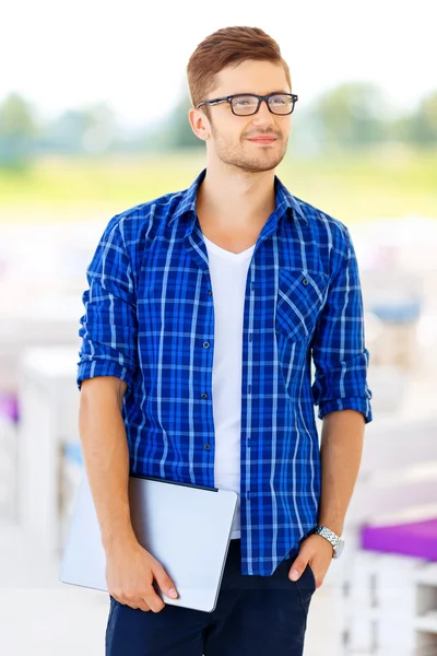 Nice freelancer holding  laptop — Stock fotografie