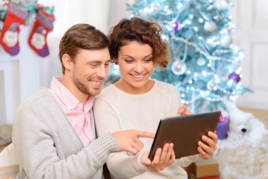 Nice couple holding laptop