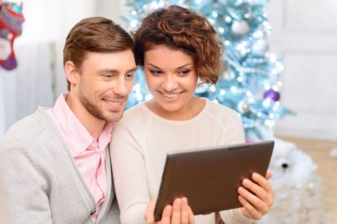 Nice couple holding laptop