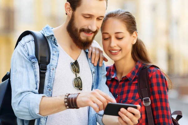 Pleasant couple holding mobile phone — Stock Photo, Image