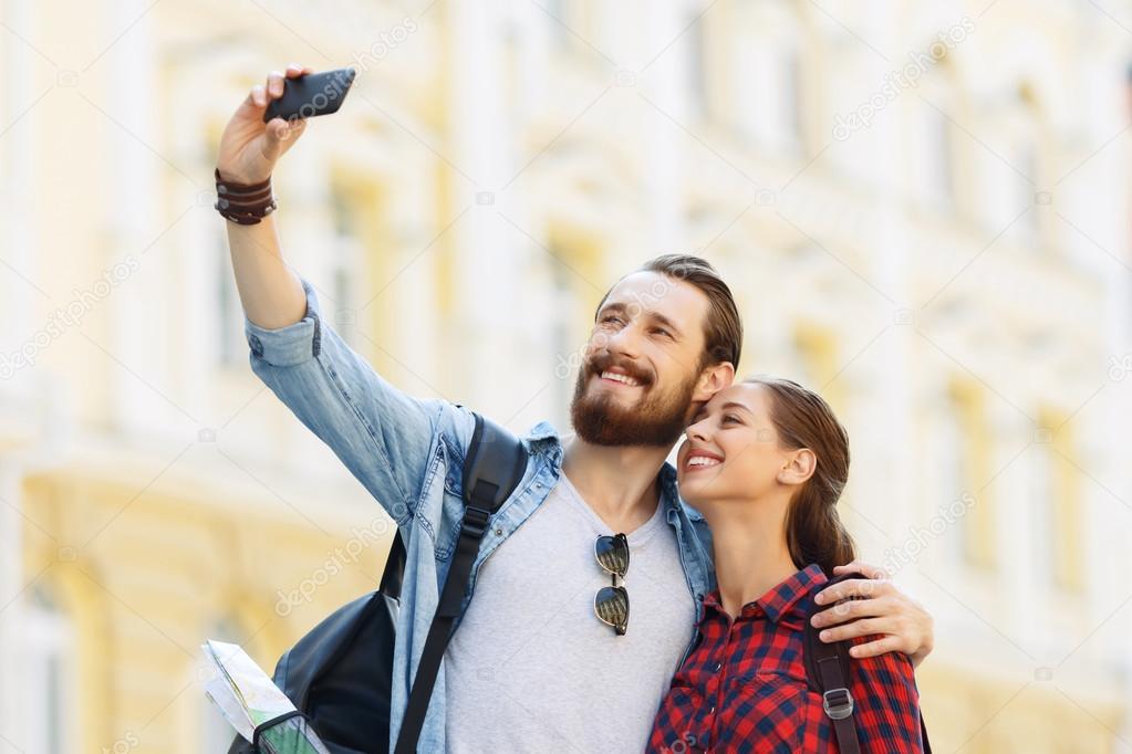 Happy tourists making selfie