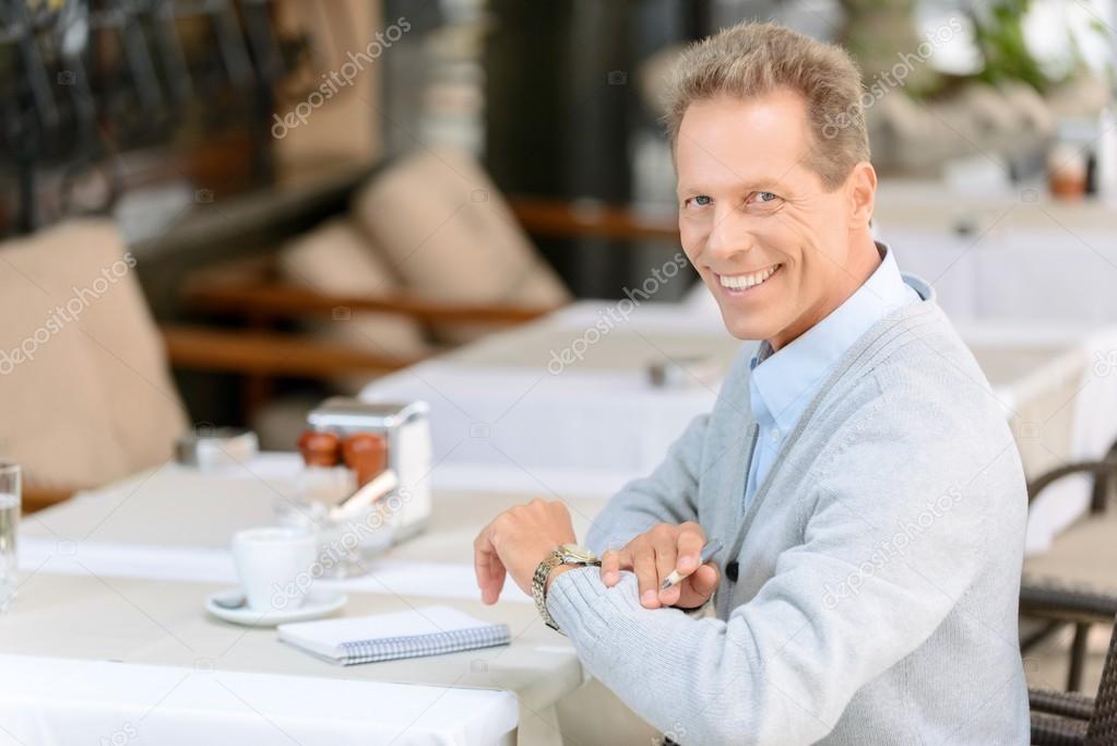 Nice man sitting at the table
