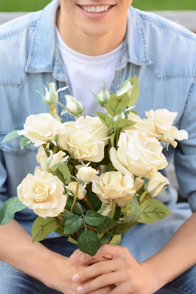 Positive boy holding flowers — Stock Photo, Image