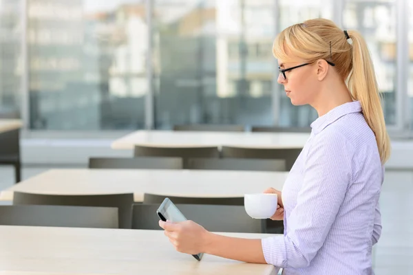 Pleasant businesswoman sitting at the table — 스톡 사진