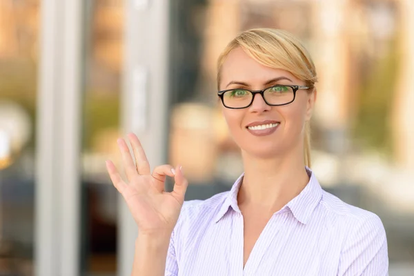 Nice businesswoman standing near office building — Stock Photo, Image