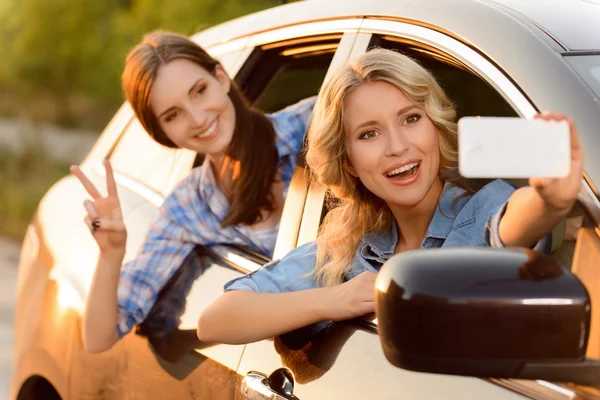 Meninas alegres sentadas no carro — Fotografia de Stock