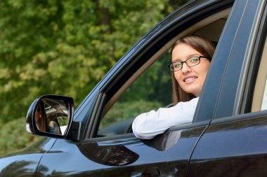 Pleasant girl driving a car