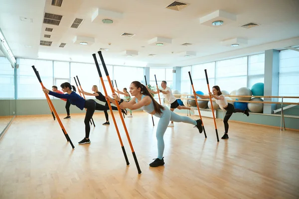 Spor sınıfındaki insanlar denge egzersizleri yapıyorlar. Fitness, spor, eğitim, spor salonu ve yaşam tarzı konsepti