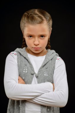 Little girl standing on black background