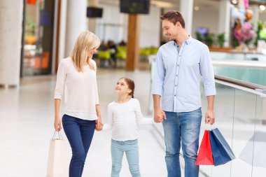 Friendly family walking around shopping mall