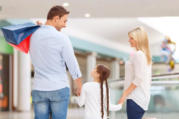 Friendly family walking around shopping mall — ストック写真