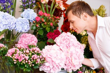 Nice man smelling the flowers