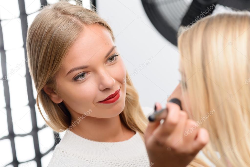 Professional makeup artist enjoys her work.