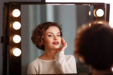 Aynanın önünde oturan çekici kız